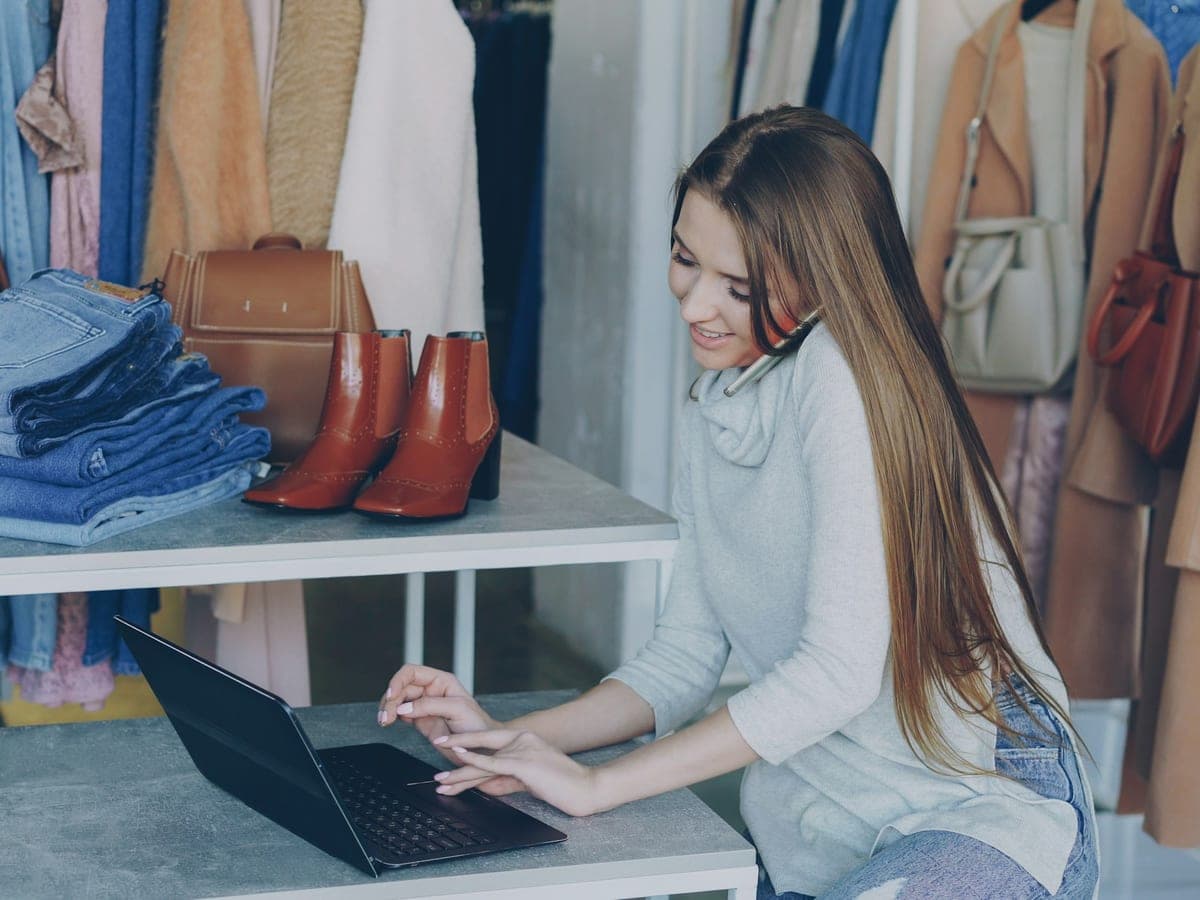 Une commerçante gérant sa boutique en ligne depuis un portable